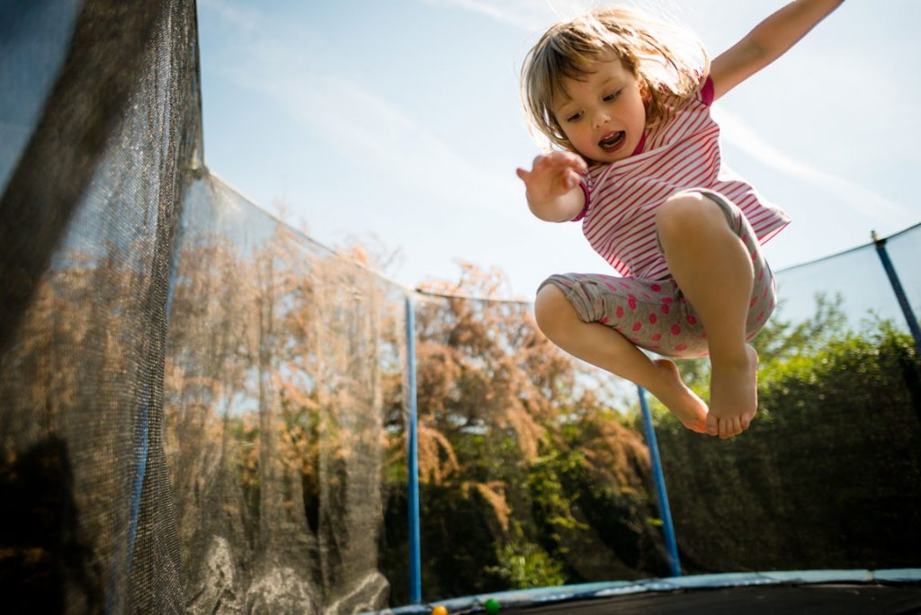 little girl bouncing on trampoline