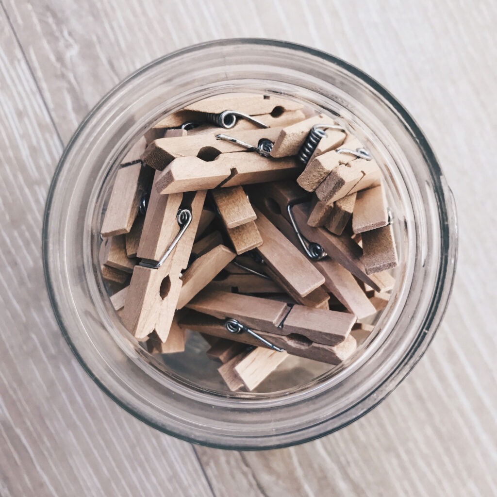 wooden clothes pins in a glass jar
